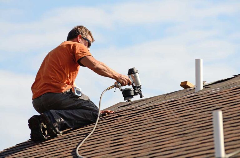Homeowner viewing roof shingles and gutters from the ground after a seasonal inspection.